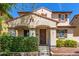 Inviting home with a covered porch, stylish front door, and colorful landscaping, creating curb appeal at 2435 N Riley Rd, Buckeye, AZ 85396