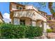 Lovely home with an arched entryway, manicured front yard, and mature bushes offering a charming appeal at 2435 N Riley Rd, Buckeye, AZ 85396