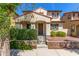 Charming home showcasing a covered porch, landscaped front yard with lush greenery, and a welcoming entrance at 2435 N Riley Rd, Buckeye, AZ 85396