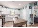 Bright kitchen with white cabinets, subway tile backsplash, stainless steel appliances, and a rustic wooden kitchen island at 2435 N Riley Rd, Buckeye, AZ 85396