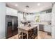 Spacious kitchen with white cabinets, stainless steel appliances, kitchen island and a view to the backyard at 2435 N Riley Rd, Buckeye, AZ 85396