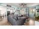 Open-concept living room with a view of the kitchen, featuring a comfortable seating area and lots of natural light at 2435 N Riley Rd, Buckeye, AZ 85396