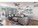 Bright living room with stylish furnishings, including a comfortable sectional sofa, patterned armchair and neutral decor at 2435 N Riley Rd, Buckeye, AZ 85396
