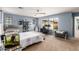 Sunlit main bedroom with a ceiling fan, and neutral carpet, providing a comfortable and functional living space at 2435 N Riley Rd, Buckeye, AZ 85396