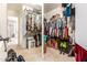 Well-organized walk-in closet with ample storage space, rods, shelves, and carpeted floors for efficient storage at 2435 N Riley Rd, Buckeye, AZ 85396