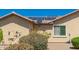Exterior shows solar panels and landscaping with stucco walls and a window at 26270 W Horsham Ct, Buckeye, AZ 85396