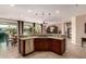 Kitchen with a breakfast bar overlooking the living area, featuring stainless steel appliances and great natural light at 26270 W Horsham Ct, Buckeye, AZ 85396
