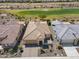 Lovely aerial view showcases a home with desert landscaping and a golf course in the background at 26421 W Zachary Dr, Buckeye, AZ 85396