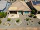 Overhead shot showing backyards with desert landscaping, covered patios, fire pit, and golf course in the background at 26421 W Zachary Dr, Buckeye, AZ 85396