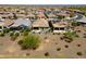 Wide aerial view of a community with desert landscaping, complemented by homes with covered patios, showcasing neighborhood charm at 26421 W Zachary Dr, Buckeye, AZ 85396
