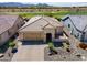 Aerial view of a lovely home with desert landscaping and brick-paved driveway at 26421 W Zachary Dr, Buckeye, AZ 85396