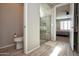 Bathroom with a glass shower and a toilet at 26421 W Zachary Dr, Buckeye, AZ 85396