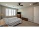Neutral bedroom with a ceiling fan and dresser at 26421 W Zachary Dr, Buckeye, AZ 85396