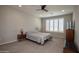 Spacious bedroom with a ceiling fan and plantation shutters at 26421 W Zachary Dr, Buckeye, AZ 85396
