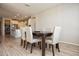 Bright dining room with seating for six, featuring tile flooring and backyard view at 26421 W Zachary Dr, Buckeye, AZ 85396