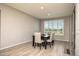 Cozy dining area features bright natural light and wood-look tile floors at 26421 W Zachary Dr, Buckeye, AZ 85396