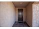 The entryway features a dark wood front door, stucco walls, recessed lighting, and stone pavers at 26421 W Zachary Dr, Buckeye, AZ 85396
