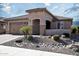 Charming home featuring desert landscaping with a tile roof and covered entryway at 26421 W Zachary Dr, Buckeye, AZ 85396