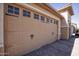 A three-car garage door in neutral color, showcasing the home's ample parking space at 26421 W Zachary Dr, Buckeye, AZ 85396