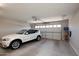 Bright and clean garage with a white BMW parked in front of the closed door at 26421 W Zachary Dr, Buckeye, AZ 85396