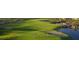 Scenic golf course with a sand trap, water feature, and well manicured green grass at 26421 W Zachary Dr, Buckeye, AZ 85396