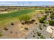 Scenic aerial view of a lush golf course, set against a desert landscape, offering a tranquil outdoor space at 26421 W Zachary Dr, Buckeye, AZ 85396