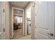 Hallway showcases a laundry room with new appliances and an office with natural light, promoting organization at 26421 W Zachary Dr, Buckeye, AZ 85396