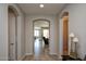 The hallway features several arched doorways, as well as wood-look tile floors at 26421 W Zachary Dr, Buckeye, AZ 85396