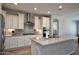 Modern kitchen featuring stainless steel appliances, granite countertops, and white cabinetry at 26421 W Zachary Dr, Buckeye, AZ 85396