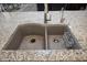 The gourmet kitchen is equipped with a dual-basin stainless steel sink and granite countertops at 26421 W Zachary Dr, Buckeye, AZ 85396