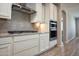The kitchen features white cabinets, stainless steel appliances, and a subway tile backsplash at 26421 W Zachary Dr, Buckeye, AZ 85396