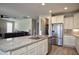 The kitchen features an island with a sink and cabinets and stainless steel appliances at 26421 W Zachary Dr, Buckeye, AZ 85396