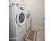 Laundry room features a modern washer and dryer with a neutral color palette and tile flooring at 26421 W Zachary Dr, Buckeye, AZ 85396