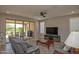 Bright living room features tile flooring, golf course views, and access to outdoor patio at 26421 W Zachary Dr, Buckeye, AZ 85396
