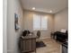 Bright office space with shutters, desk, piano, and tile floors, perfect for focused work and creativity at 26421 W Zachary Dr, Buckeye, AZ 85396