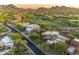Stunning aerial view of a community with lush landscaping, a golf course, and mountain views at 29308 N 108Th N Pl, Scottsdale, AZ 85262