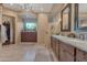 Bright bathroom boasting double sinks, granite countertops, and ample cabinet space at 29308 N 108Th N Pl, Scottsdale, AZ 85262