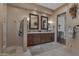 Elegant bathroom featuring a double vanity, decorative mirrors, and neutral color palette at 29308 N 108Th N Pl, Scottsdale, AZ 85262