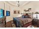 Comfortable bedroom with a wrought iron bed, southwestern decor, and a large window for natural light at 29308 N 108Th N Pl, Scottsdale, AZ 85262