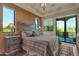 Comfortable bedroom with a decorative headboard, bedside tables with lamps, and a balcony at 29308 N 108Th N Pl, Scottsdale, AZ 85262