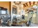 Elegant dining room featuring a unique chandelier and a round glass table with seating for six at 29308 N 108Th N Pl, Scottsdale, AZ 85262