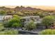 Stunning exterior view of a luxury home surrounded by lush desert landscaping and scenic mountain views at 29308 N 108Th N Pl, Scottsdale, AZ 85262