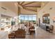 Spacious living room featuring a curved window wall and an inviting fireplace at 29308 N 108Th N Pl, Scottsdale, AZ 85262