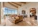 Elegant living room featuring large windows, a comfortable seating area, and travertine flooring at 29308 N 108Th N Pl, Scottsdale, AZ 85262