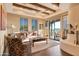 Bright living room with beamed ceilings, a fireplace, and access to an outdoor patio at 29308 N 108Th N Pl, Scottsdale, AZ 85262