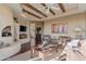 Inviting living room featuring wood-beamed ceilings, a fireplace, and a southwestern-inspired decor at 29308 N 108Th N Pl, Scottsdale, AZ 85262
