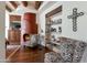 Inviting living room featuring a unique fireplace, wooden beams, and stylish zebra print armchairs at 29308 N 108Th N Pl, Scottsdale, AZ 85262