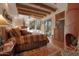 Main bedroom with wooden beams, southwestern decor, and a cozy fireplace at 29308 N 108Th N Pl, Scottsdale, AZ 85262