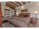 Spacious main bedroom showcasing wooden beams, a cozy seating area, and Southwestern decor at 29308 N 108Th N Pl, Scottsdale, AZ 85262