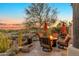 Inviting outdoor patio with a fire pit, chairs and expansive desert views at 29308 N 108Th N Pl, Scottsdale, AZ 85262